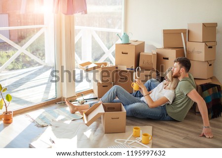 Couple moving new home. Happy married people buy new apartment