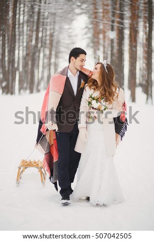 Winter wedding. Beautiful young couple in the woods.