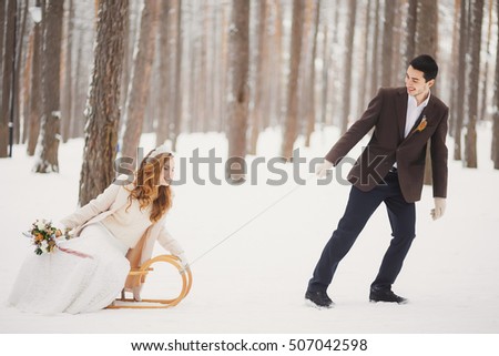 Winter wedding. Beautiful young couple in the woods.