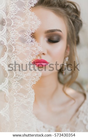 beauty young woman throw white lace close up, bride under veil, real bride, makeup and nails