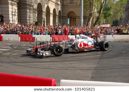 BUDAPEST, HUNGARY-  MAY 1: F1 driver Jenson Button does some burnouts for his fans on May 1, 2012 on streets in Budapest.