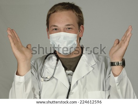 Doctor in mask throws his hands up in the air.