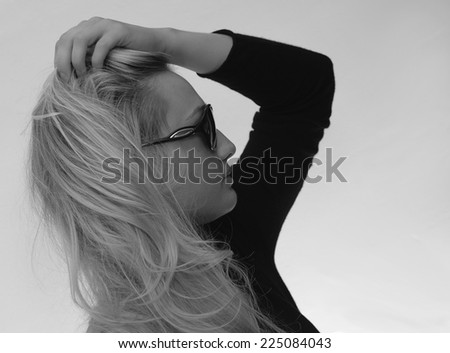 Close up profile portrait of the face of a beautiful elegant  blonde woman in trendy sunglasses