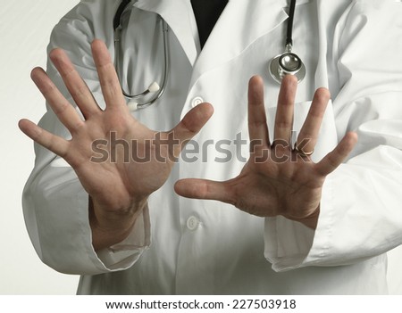 Doctor in Lab Coat Gestures \'No\'.