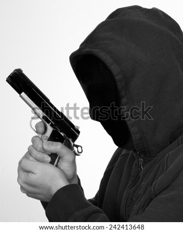 Hooded man points a gun