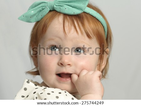 Baby girl with a finger in her mouth