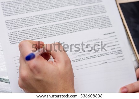A girl is filling in document