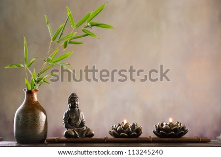 Buddha with candle and bamboo religious concept Buddha with candle and bamboo religious concept