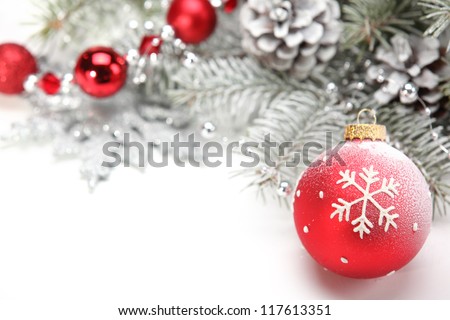Closeup of Christmas ball with pine branch on abstract background.