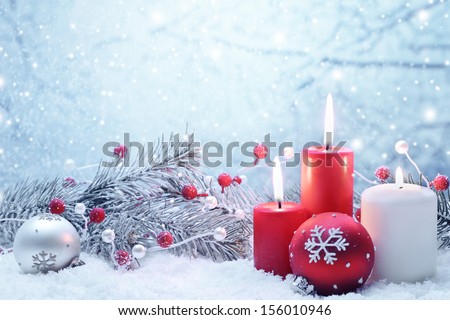 Christmas decoration with candles fir branch and balls on snow Christmas decoration with candles fir branch and balls on snow