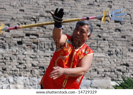 BEIJING - APRIL 12: an old man was performing a kind of Chinese ancient weapon in Ming rampart park of Beijing.