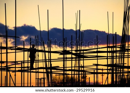 Construction Site,silhouette of Builder looking at Sunset/Sunrise