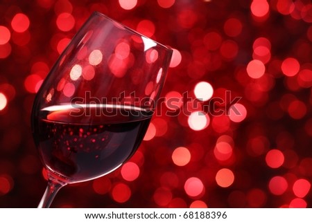 Close up on Glass of Red Wine with Lights Background.