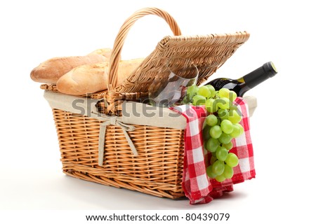 Picnic basket filled with fruit,bread and red wine.