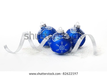 Blue christmas balls with ribbon on white background.
