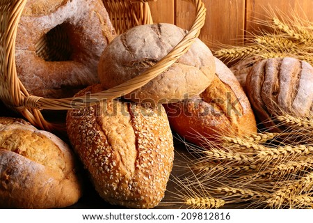 Whole grain wheat bread in basket with wheat ears.