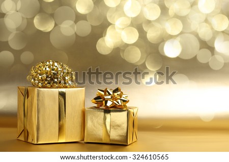 Golden gift boxes on abstract background
