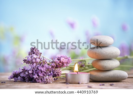 Spa still life with stack of stones,burning candles and lavenders