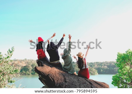 Group of Four best friends laughing and having a good time while hiking in wild forest, beauty of nature. Relax time on holiday concept travel, Thailand.