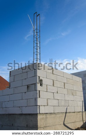 Unfinished house wall made from Aerated concrete blocks with reinforced pillar