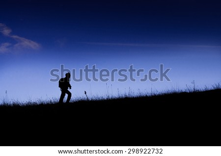 Climber silhouette on the grassland