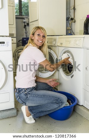 Woman filling a washing machine