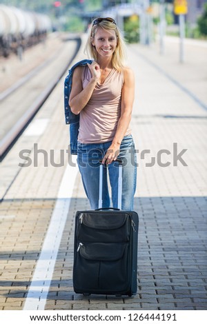Woman with suitcase on the platform