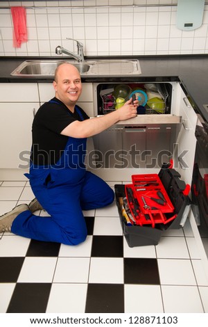 Technician repairs a dishwasher