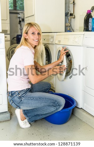 Woman filling a washing machine