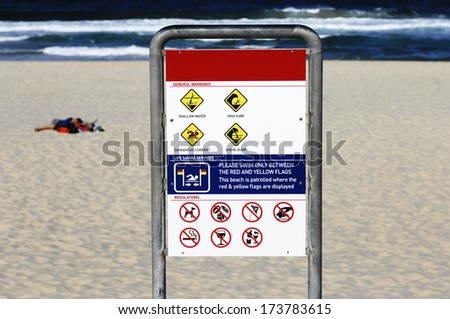 Security sign on the beach