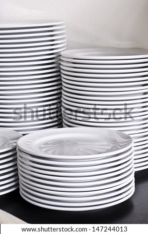 Many white different plates stacked together.