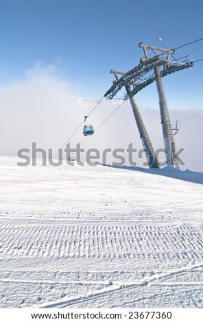 Groomed snow and ski-lift gondola