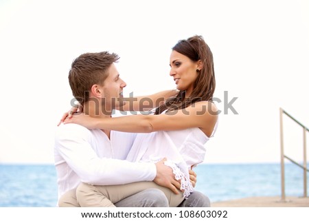 Portrait of a sweet couple  looking at each other enjoying their time on a beach