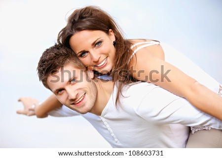 Portrait of a happy young couple enjoying their summer vacation, isolated on bright background