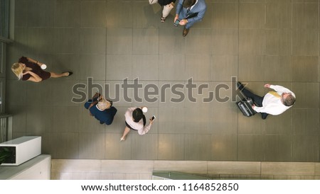 Top view of defocused business people in a lobby. Business people walking through a office hallway.