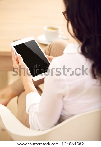Corporate assitant checking information about business marketing through her digital tablet