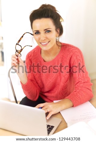 Woman at home with laptop enjoying her job as a freelancer