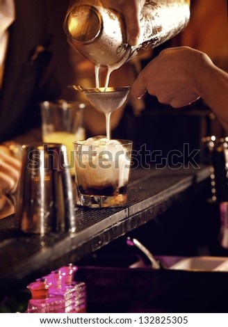 Cold cocktail drink being prepared  by the bartender