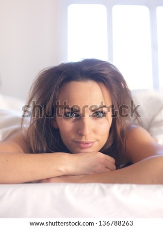 Closeup of a woman with messy bedroom hair looking at you