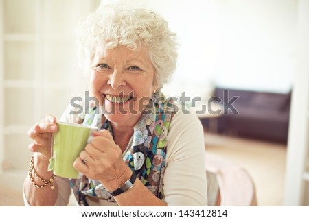 Closeup of a charming old lady drinking her tea