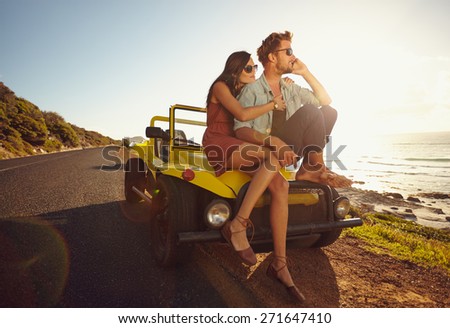 Young man and young woman on road trip on a beautiful summer's day.