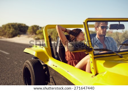 Young man and young woman on road trip on a beautiful summer\'s day.