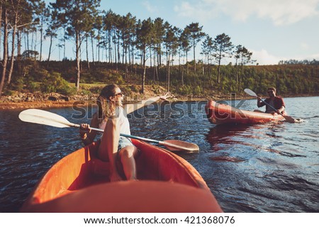 Young couple canoeing on the lake. Young kayakers enjoying a day at the lake.