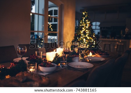 Specially decorated christmas table at home for dinner. Beautifully set dining table for Christmas Eve.