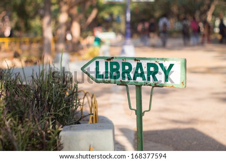 Library sign and direction board on a road in university