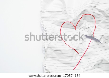 paper crushed with heart drawn on it on an isolated background