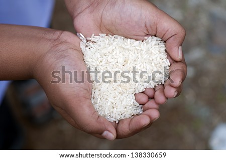 Hands holding rice form a love symbol