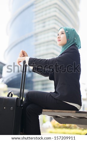 Young pretty business woman wearing scarf waiting her partner