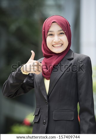 Image of Executive women with scarf woman raise her thumb