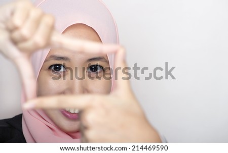 Closeup portrait of young beautiful executive making frame with her hands